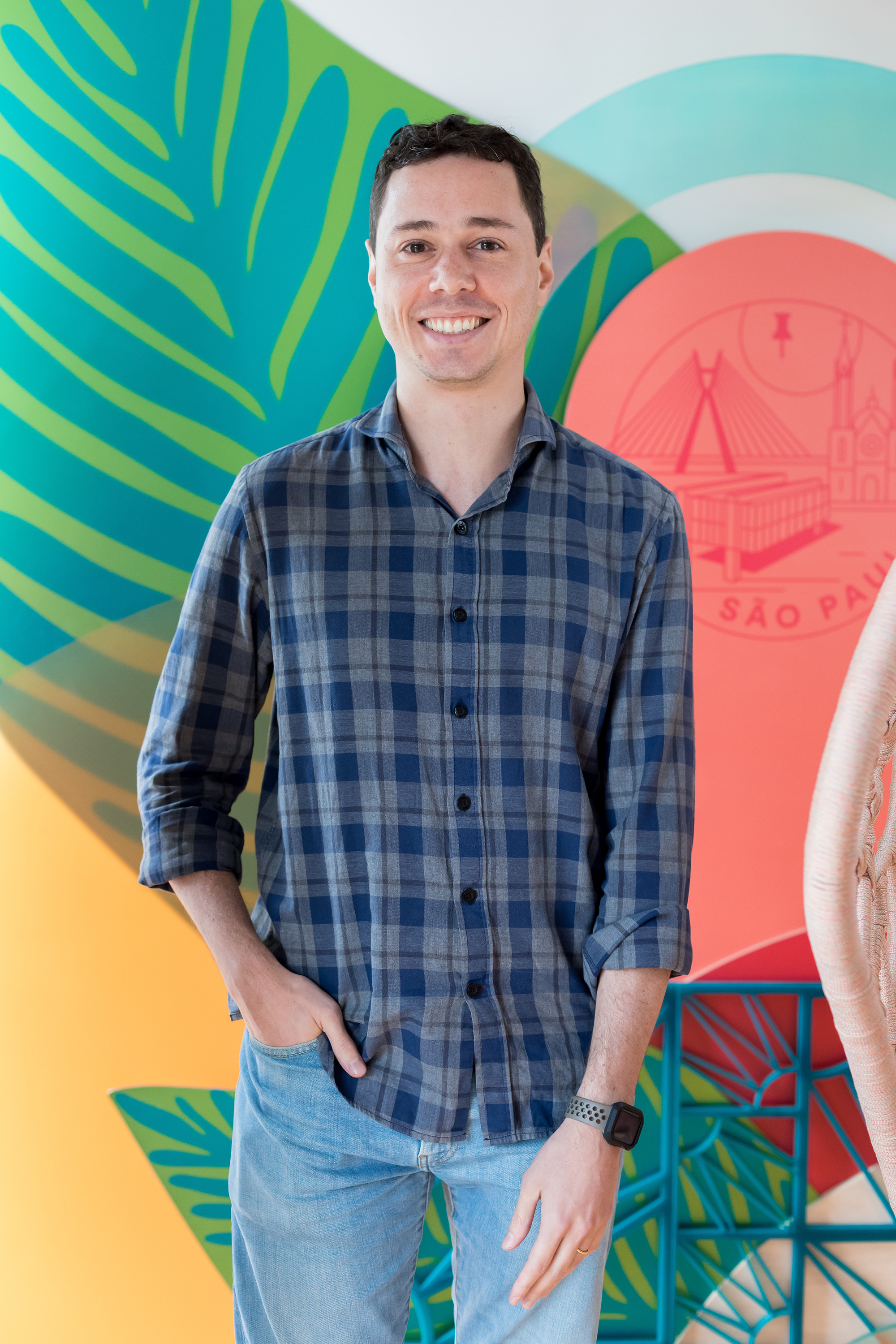 a man standing in front of a colorful wall