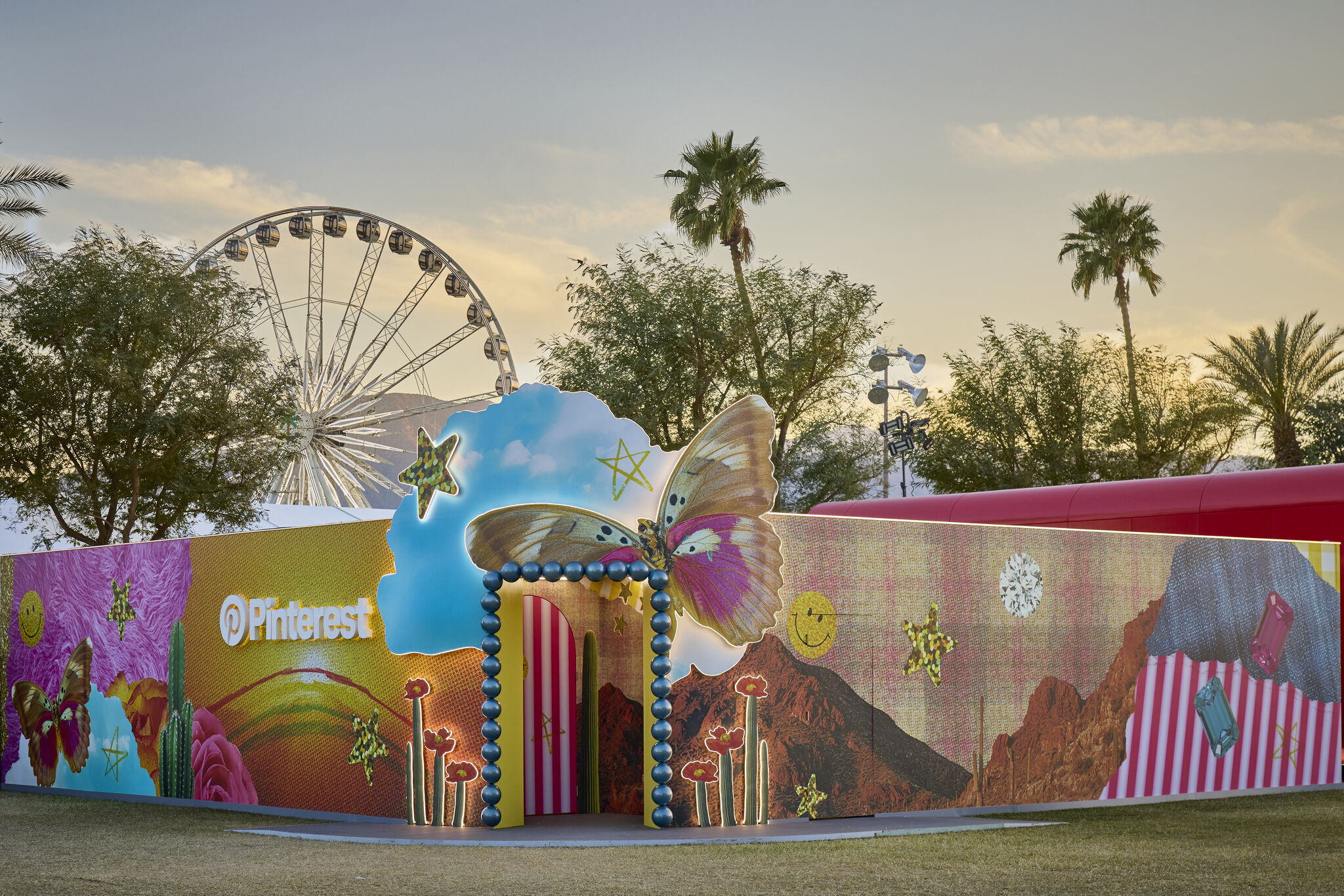 a large inflatable structure with a ferris wheel in the background